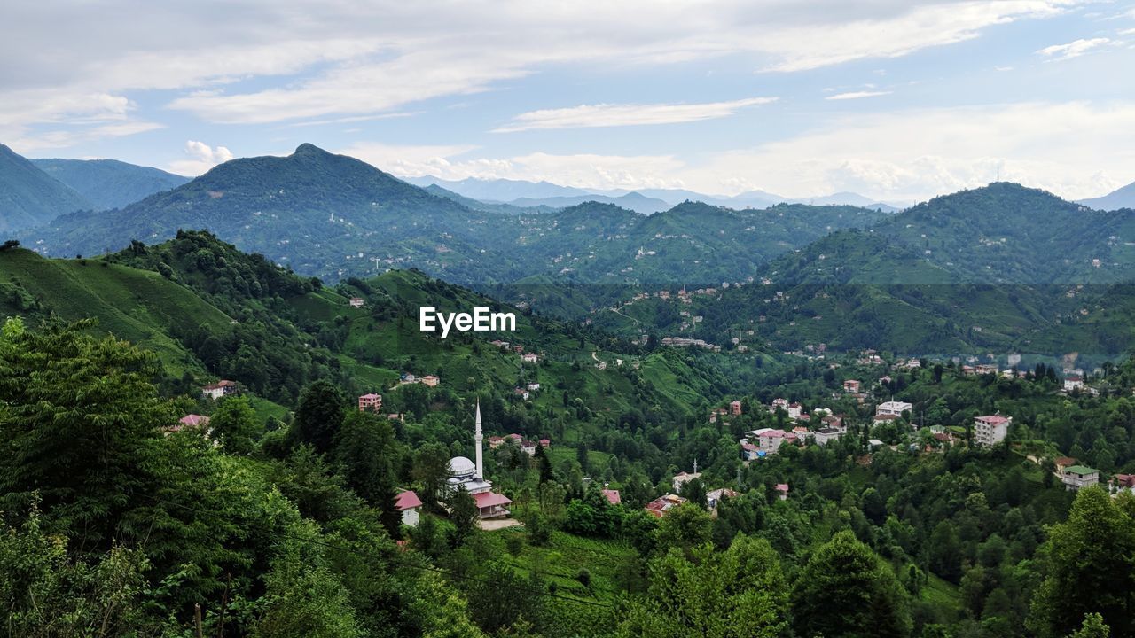 High angle view of townscape and mountains against sky