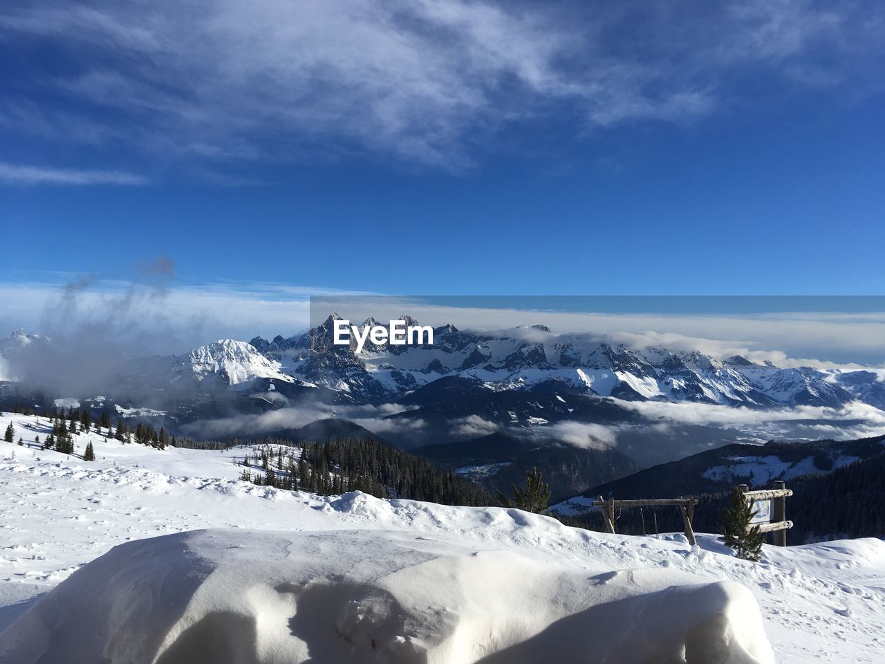 Scenic view of snowcapped mountains against blue sky