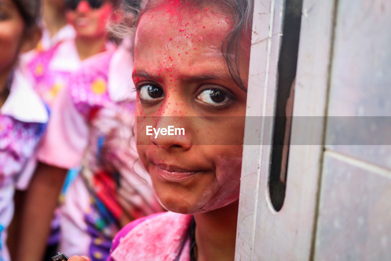Close-up portrait of young woman during holi