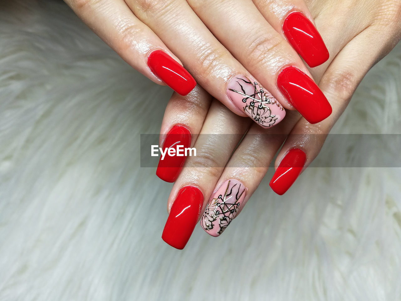 Cropped hand on woman with nail polish over table