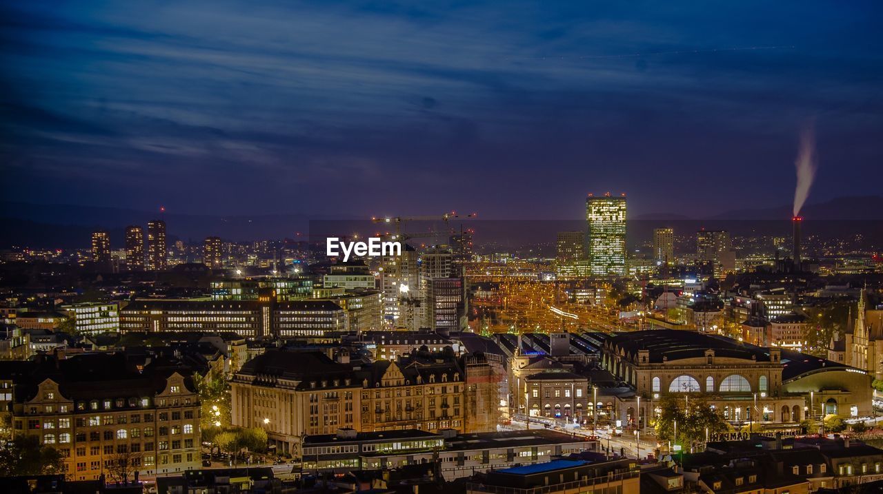 High angle view of city lit up at night