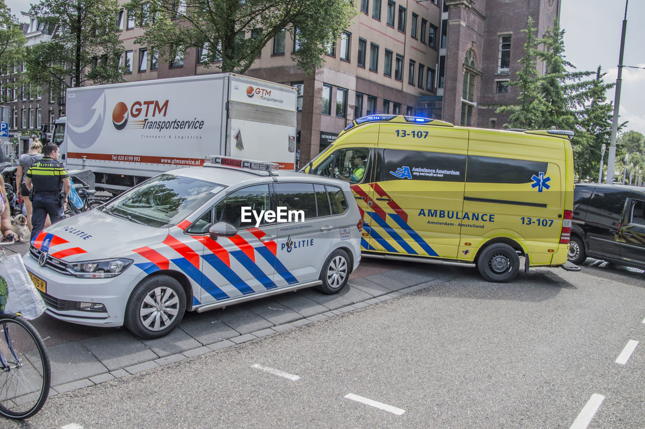 CARS ON CITY STREET AGAINST BUILDINGS