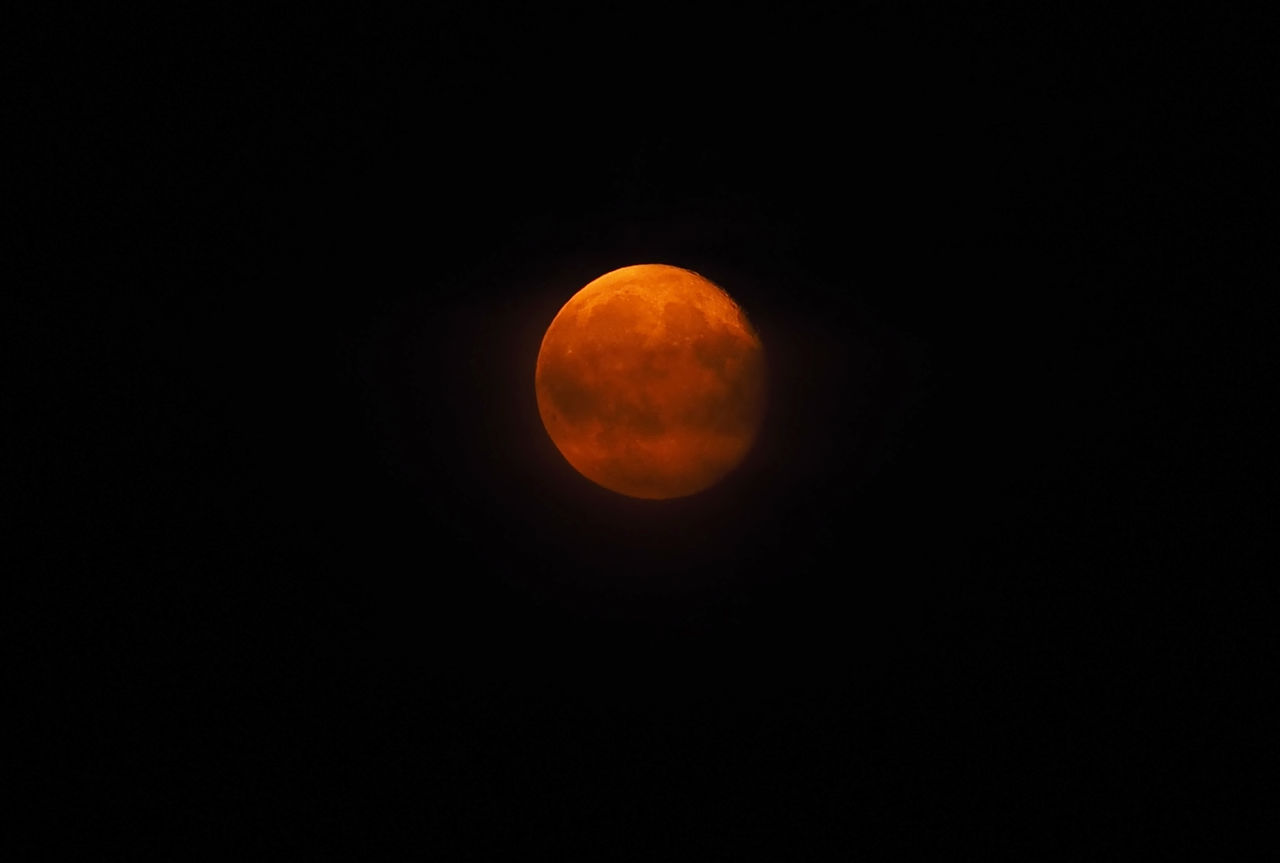 LOW ANGLE VIEW OF MOON IN SKY AT NIGHT