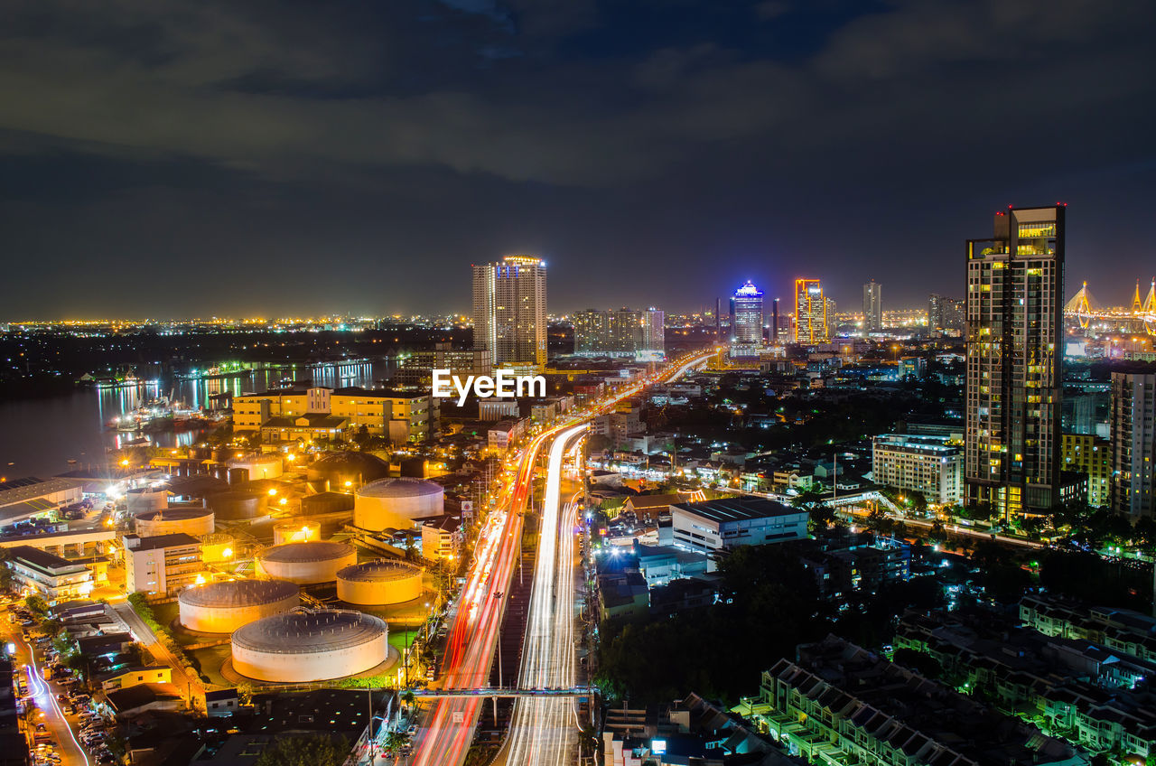 High angle view of illuminated cityscape against sky at night