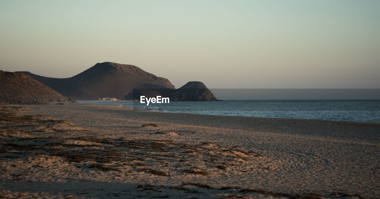 Scenic view of sea against clear sky during sunset