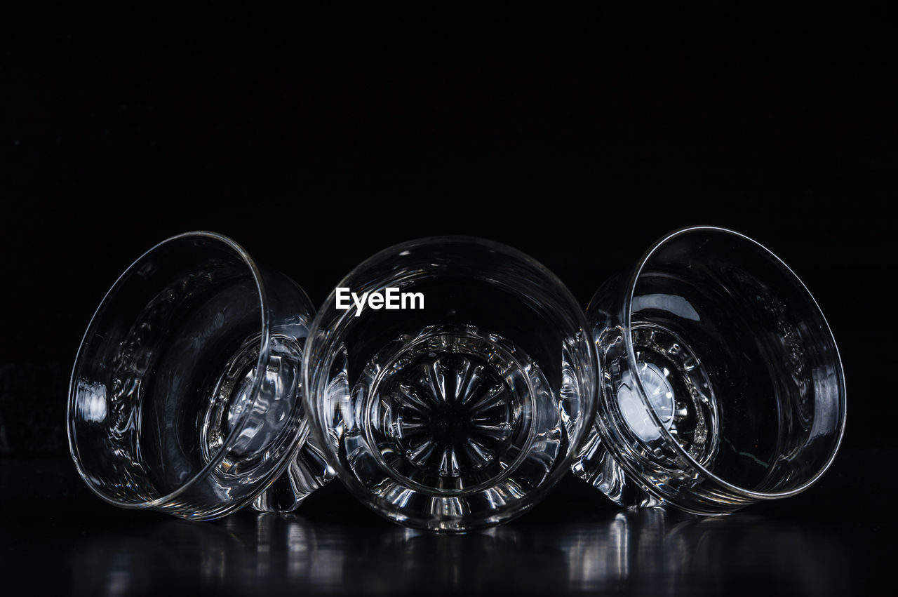 Close-up of glass bowls against black background