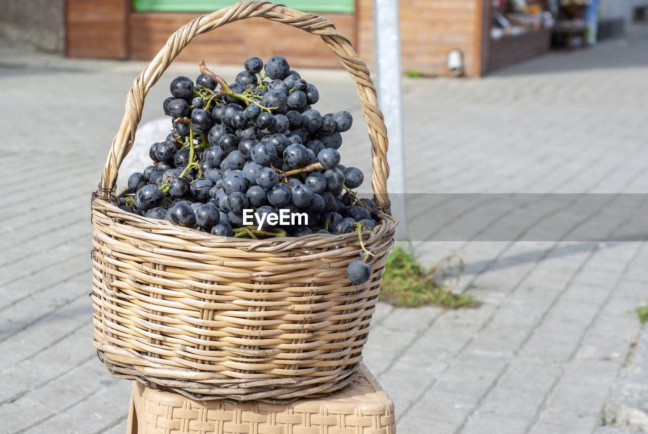 CLOSE-UP OF FRUIT IN BASKET ON STREET