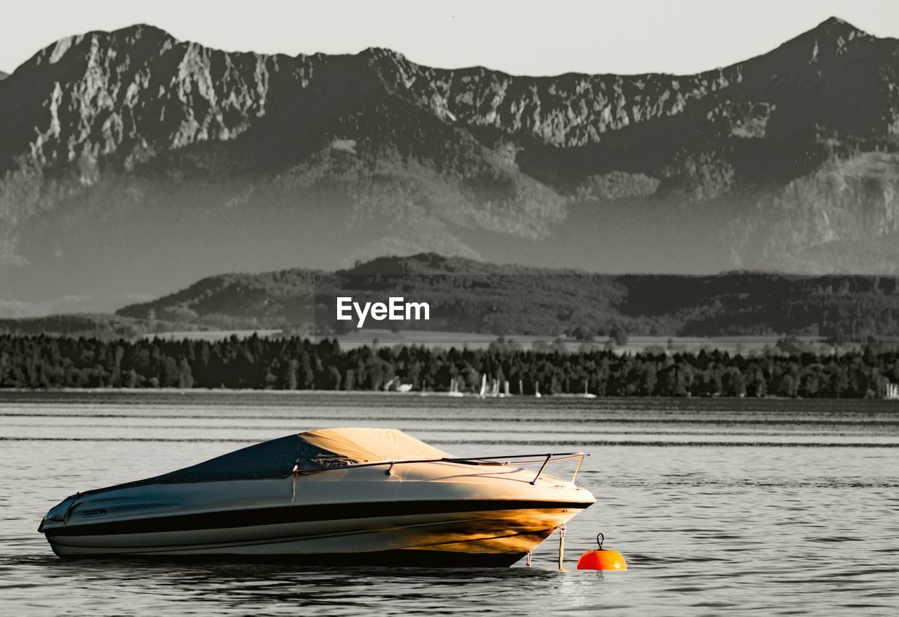 Boat in lake against mountains
