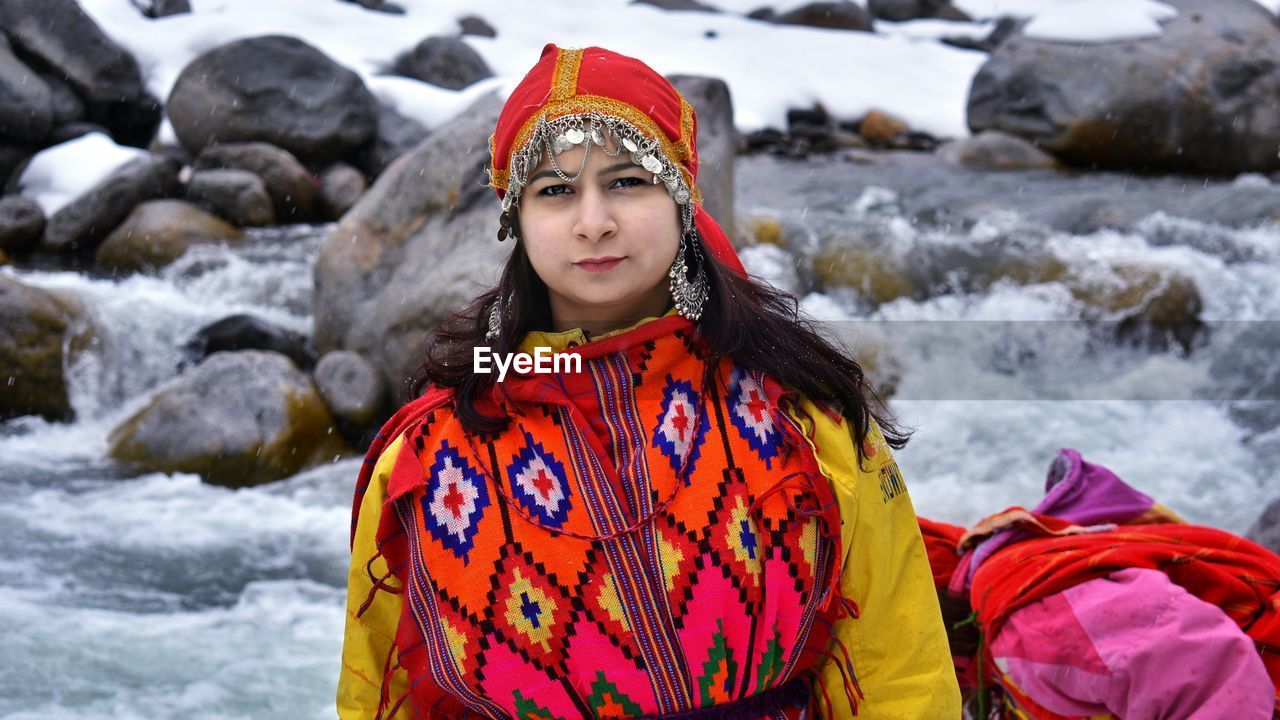 Beautiful girl in traditional wear in snow fall in manali / india