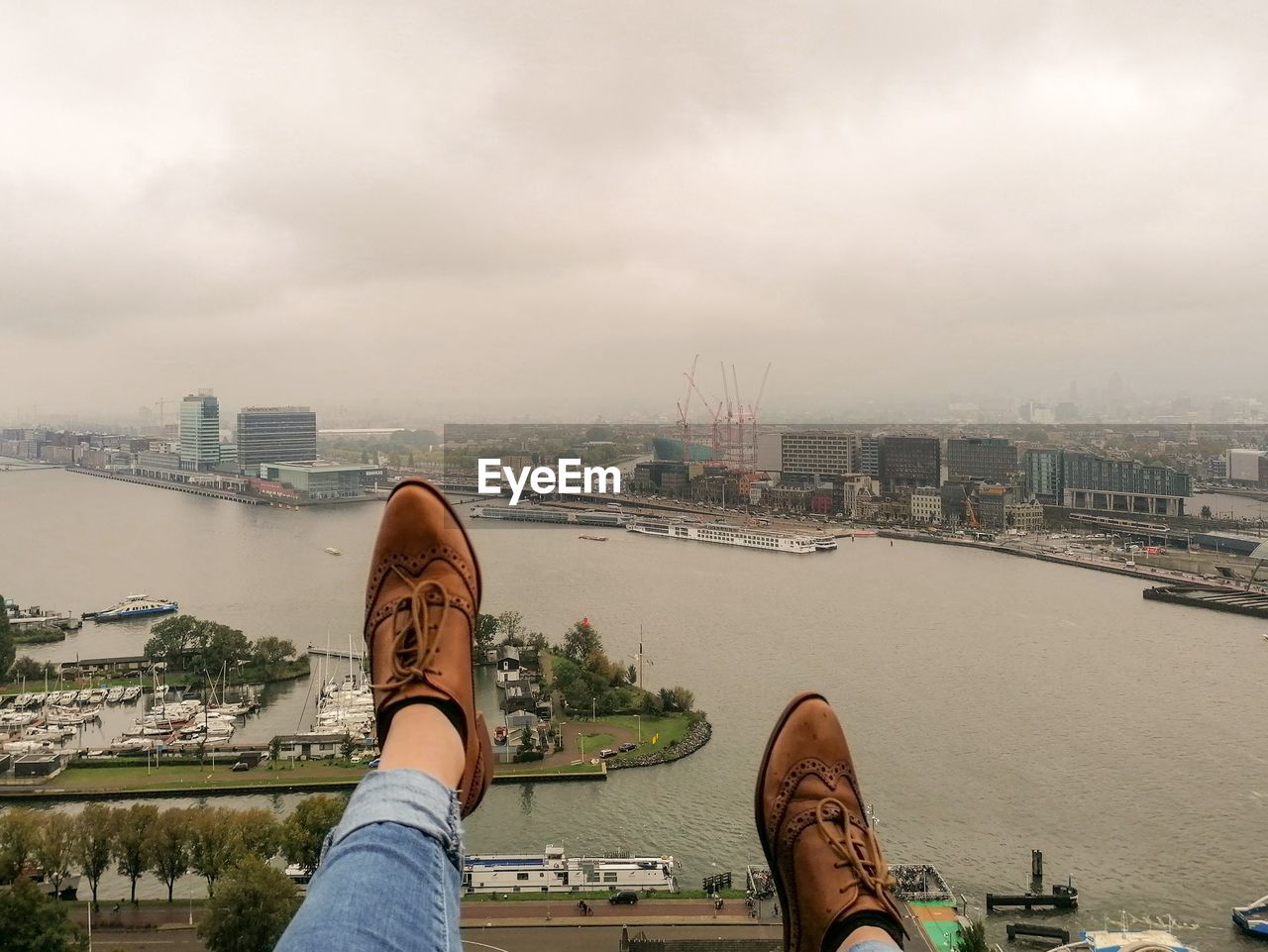 Low section of woman with cityscape in background