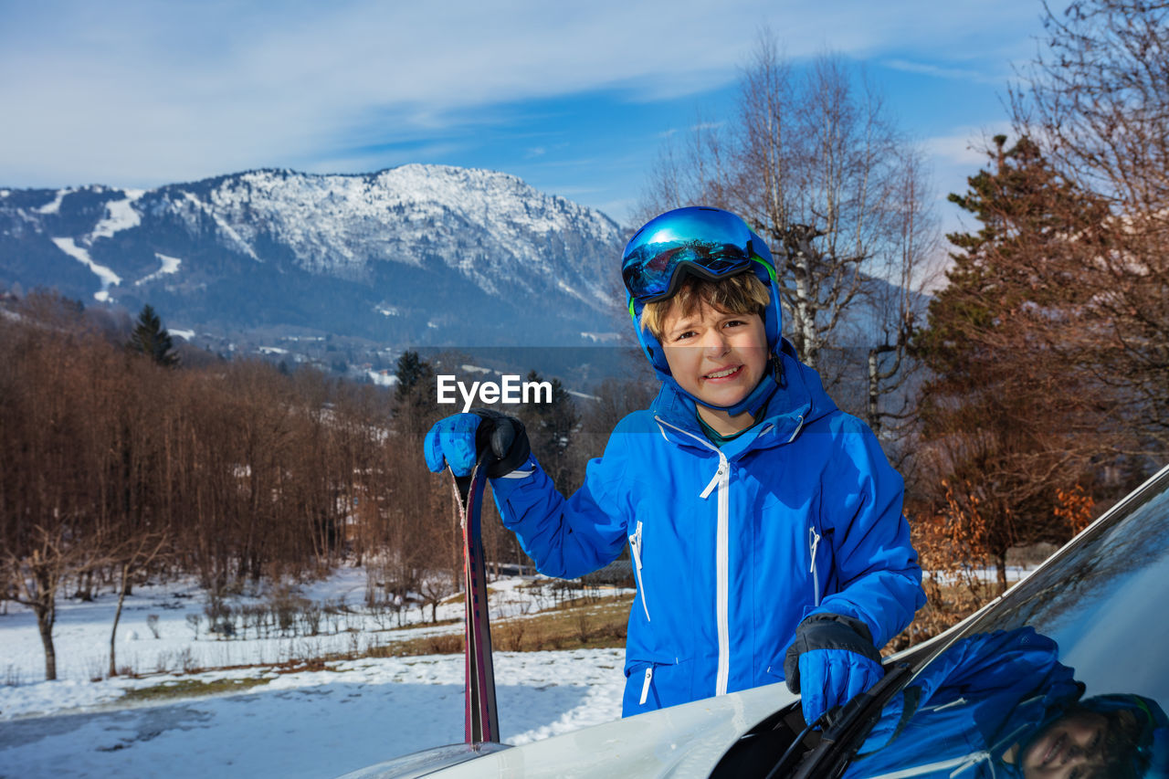 portrait of man working on snow covered mountain