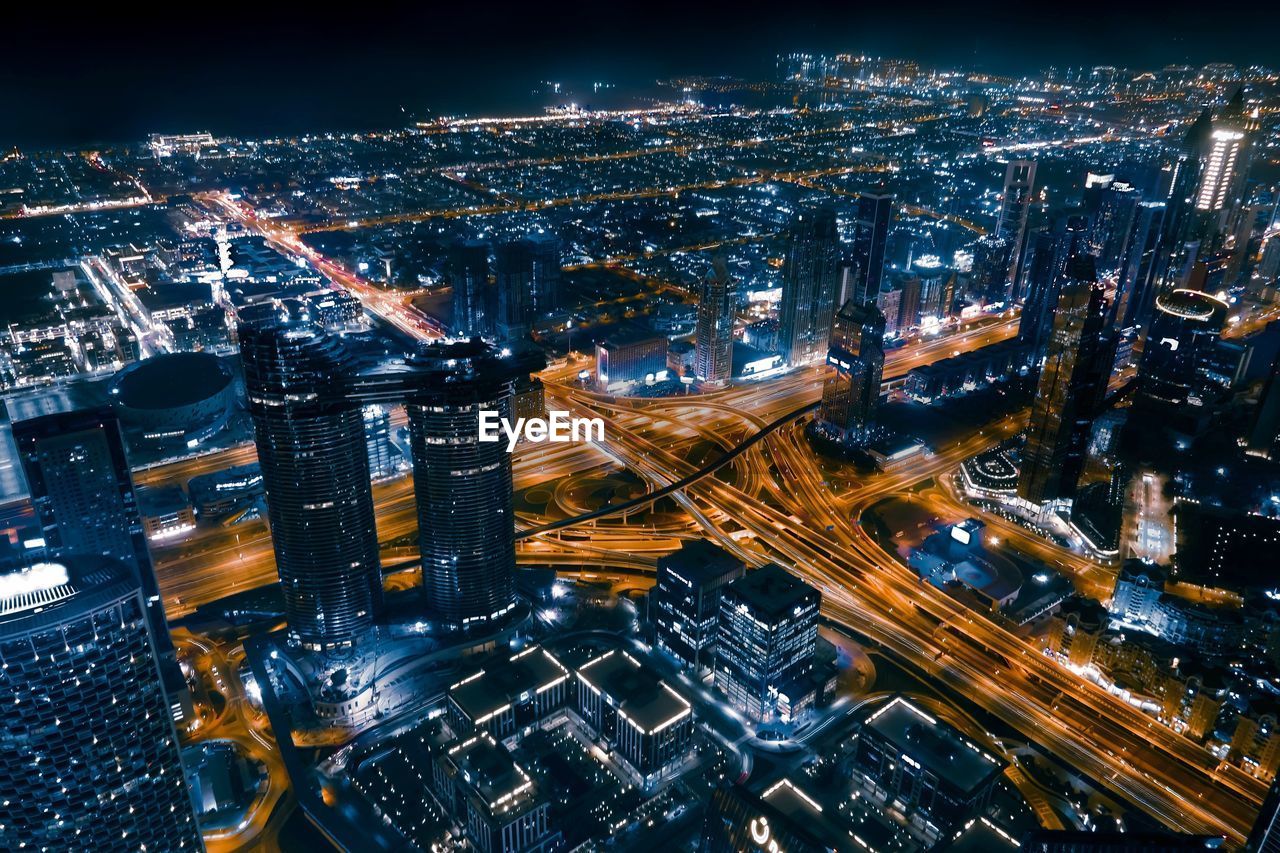 High angle view of illuminated city buildings at night