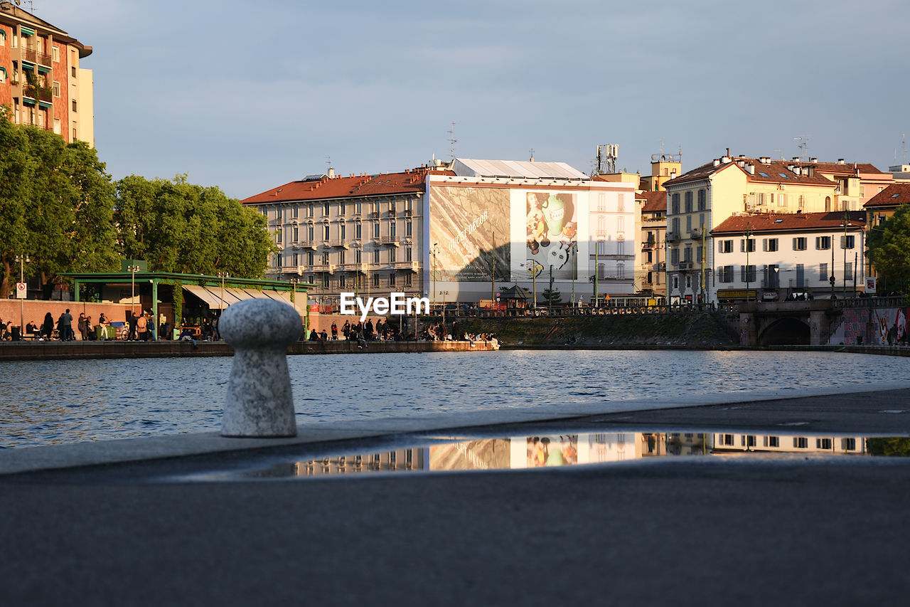 Bridge over river against buildings in city