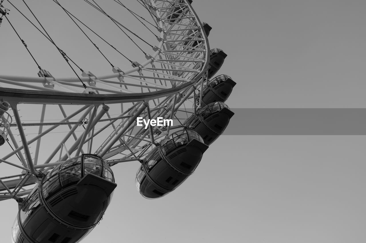 Low angle view of london eye against clear sky