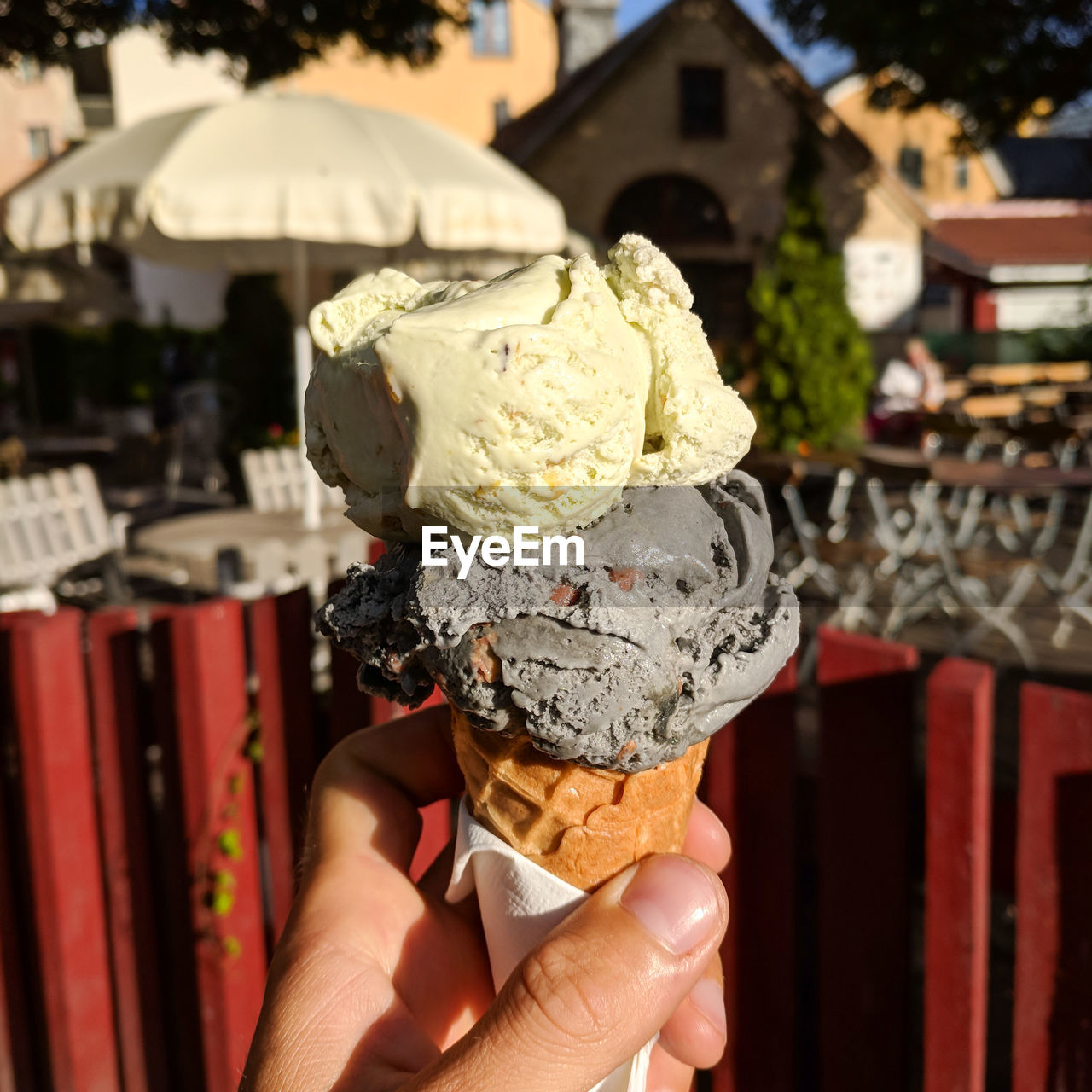Scoops of grey and yellow ice cream in a cone