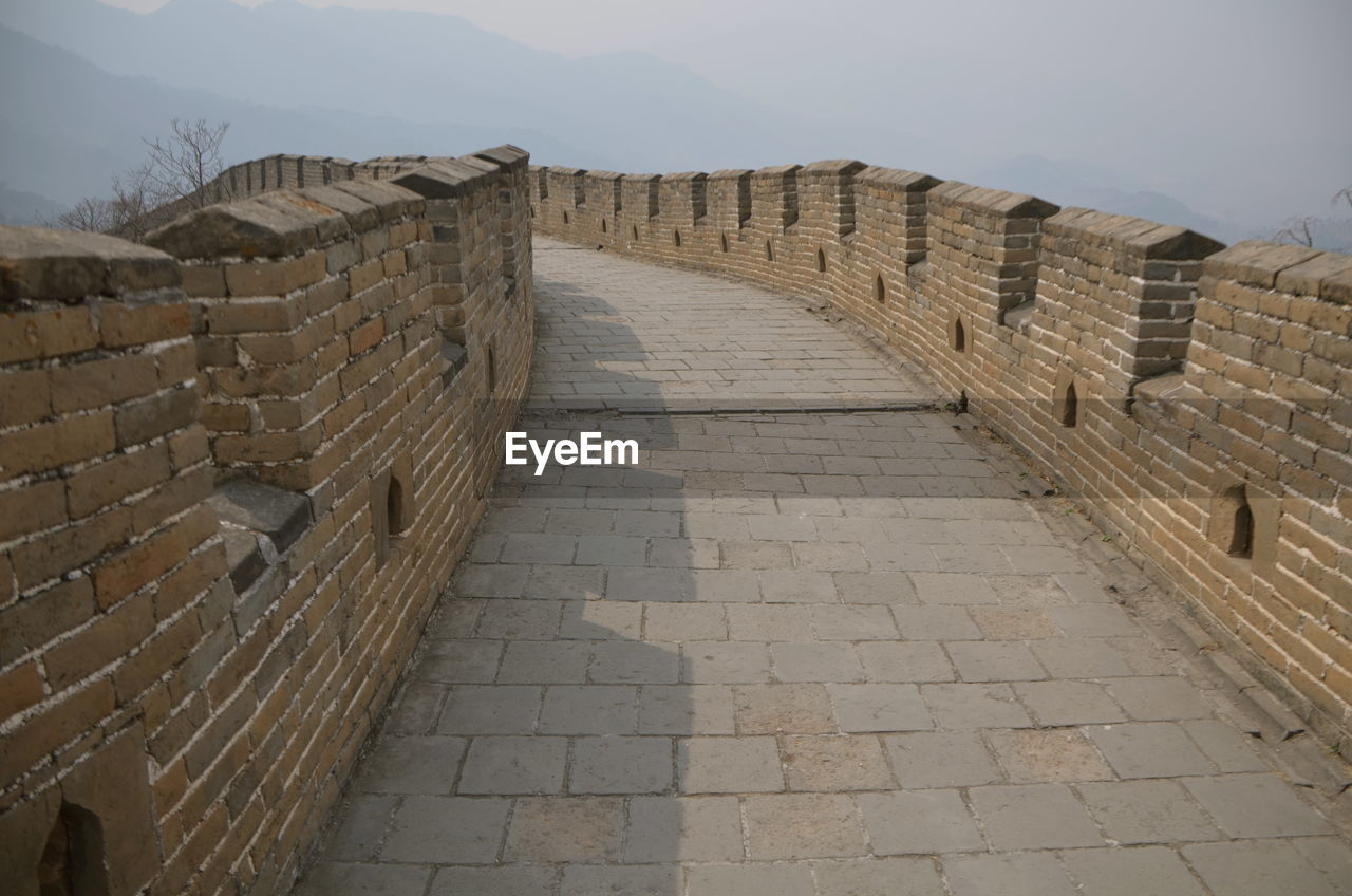 View of great wall of china leading towards mountain