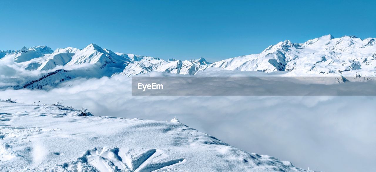 Scenic view of snowcapped mountains against sky