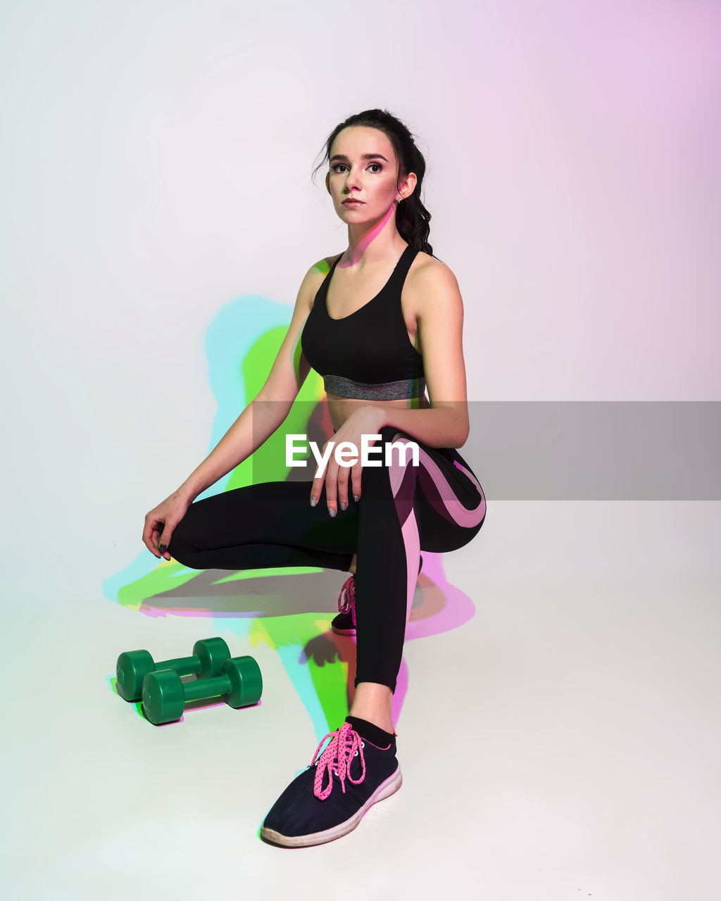 Attractive woman doing stretching exercise or yoga moves with glitch duotone effect