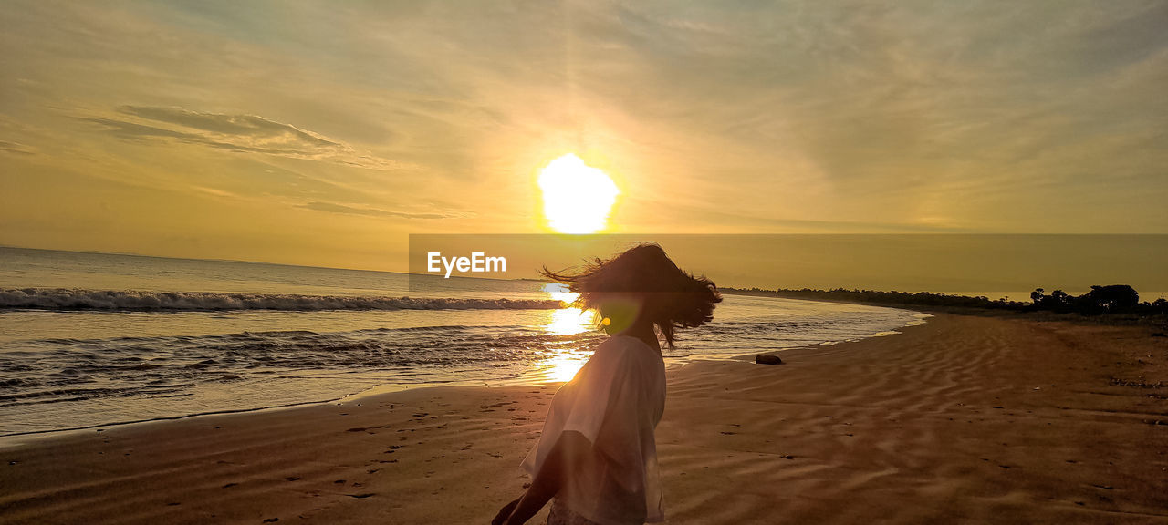 SCENIC VIEW OF BEACH DURING SUNSET