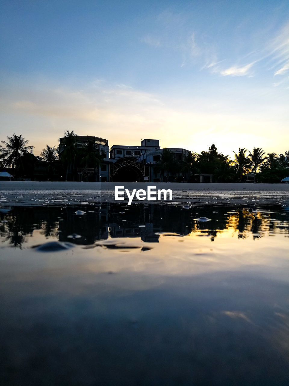 SCENIC VIEW OF LAKE BY BUILDINGS AGAINST SKY