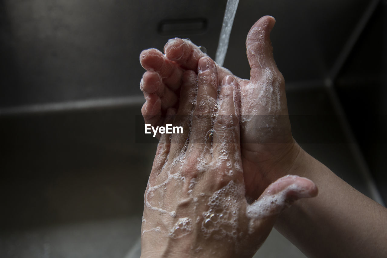 Someone washing their hands in the sink