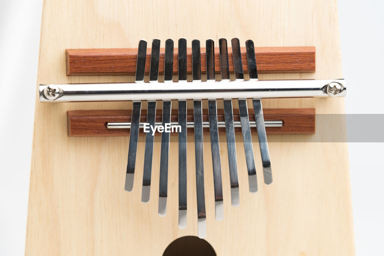 Close-up of mbira against white background