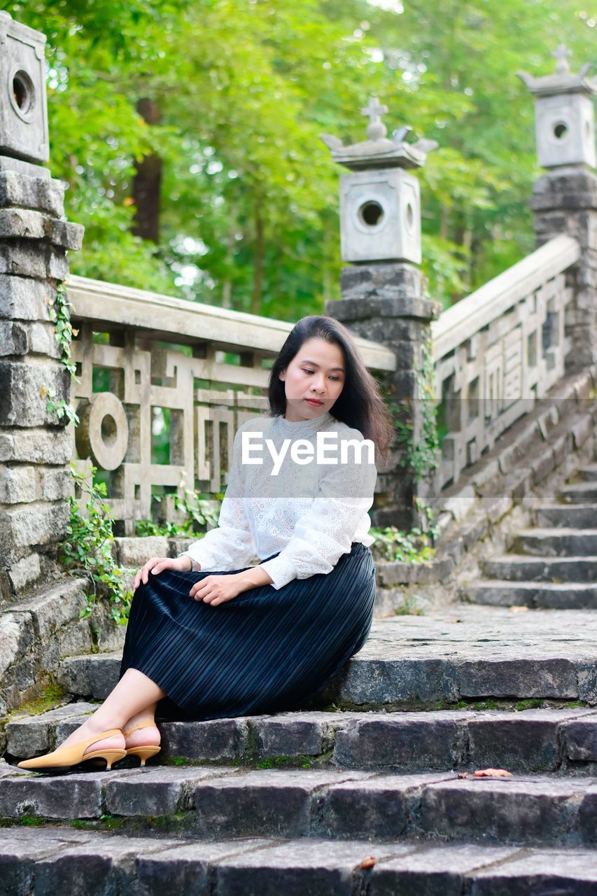 Young woman sitting on staircase