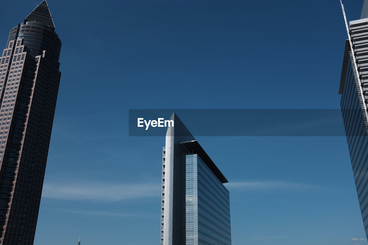 Low angle view of messeturm against blue sky