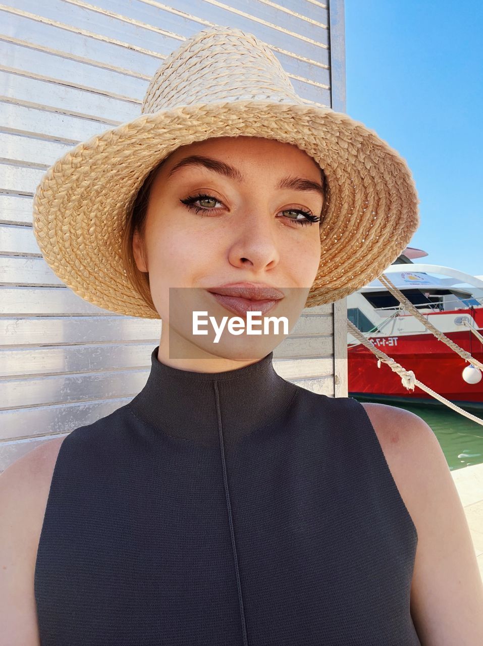 Portrait of young woman wearing hat