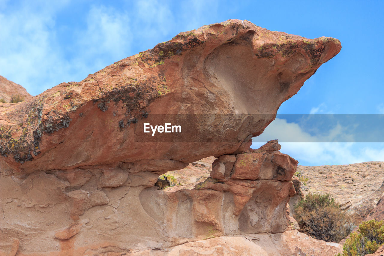 Low angle view of rock formation against sky