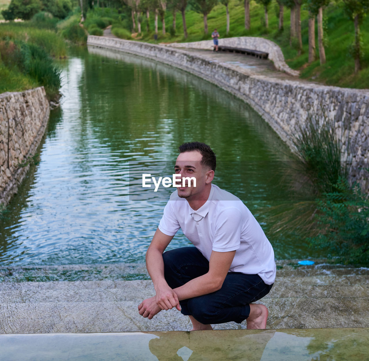 Portrait of young man standing in river