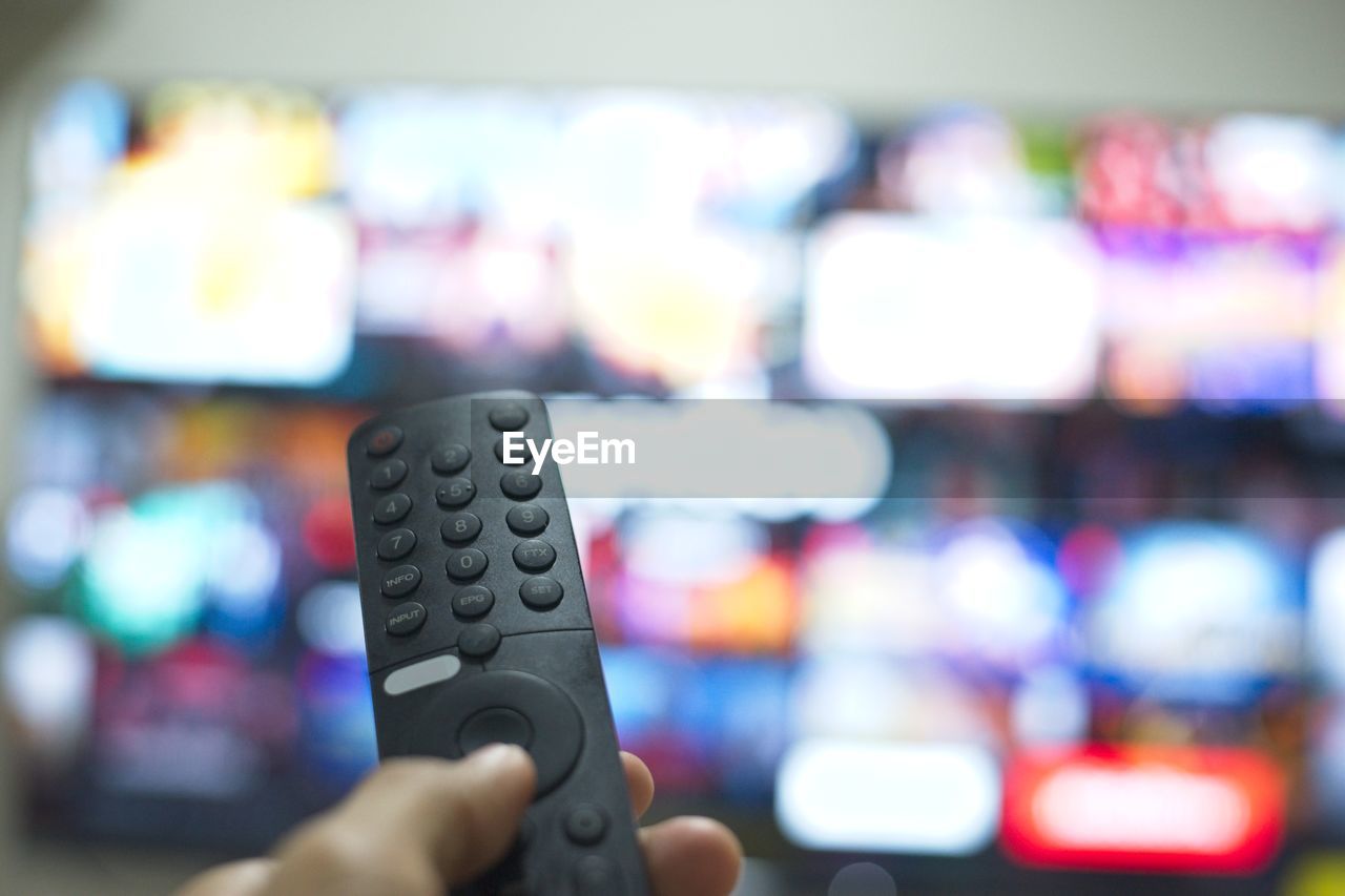 hand, technology, television set, remote control, control, close-up, one person, holding, indoors, adult, focus on foreground, leisure activity, arts culture and entertainment