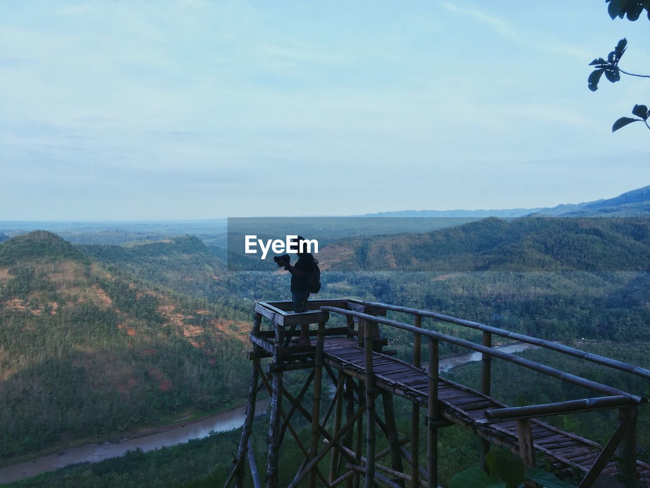 PEOPLE LOOKING AT MOUNTAINS