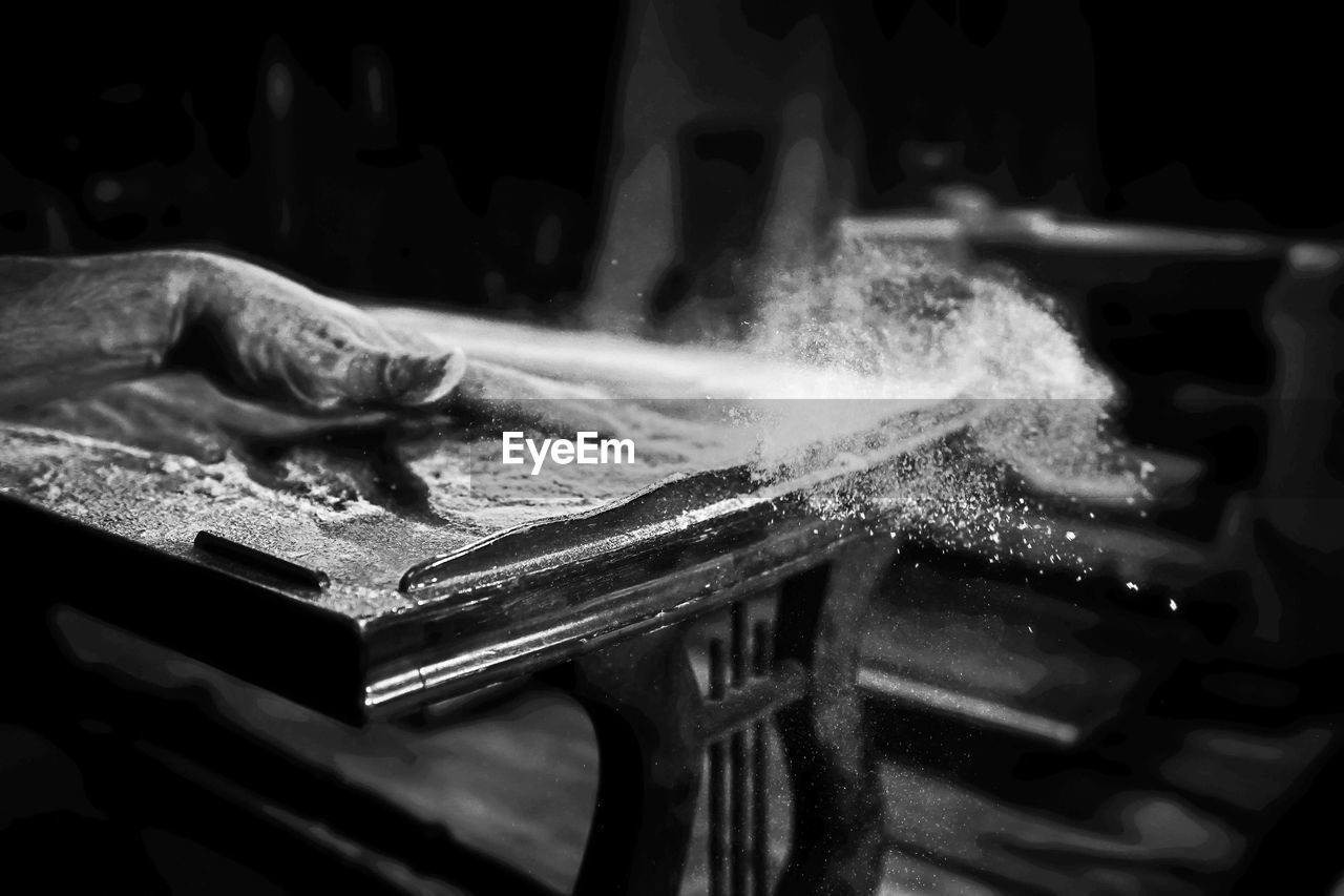 CLOSE-UP OF MAN WORKING AT KITCHEN