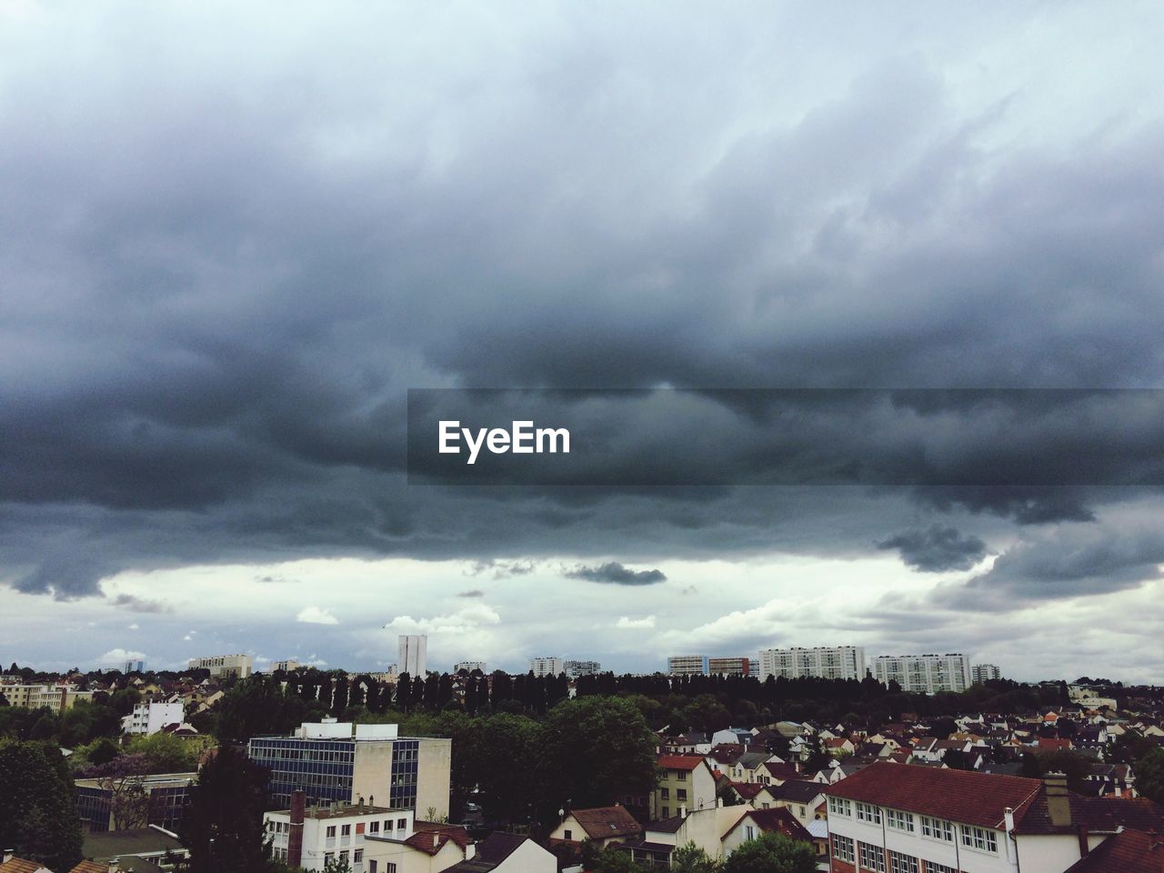 HOUSES AGAINST CLOUDY SKY