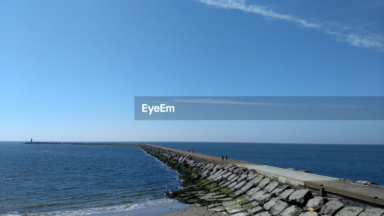 Scenic view of seascape against blue sky