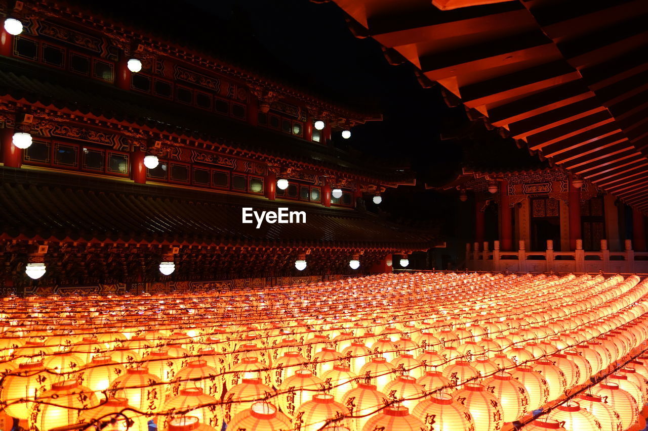 GROUP OF PEOPLE IN ILLUMINATED ROOM