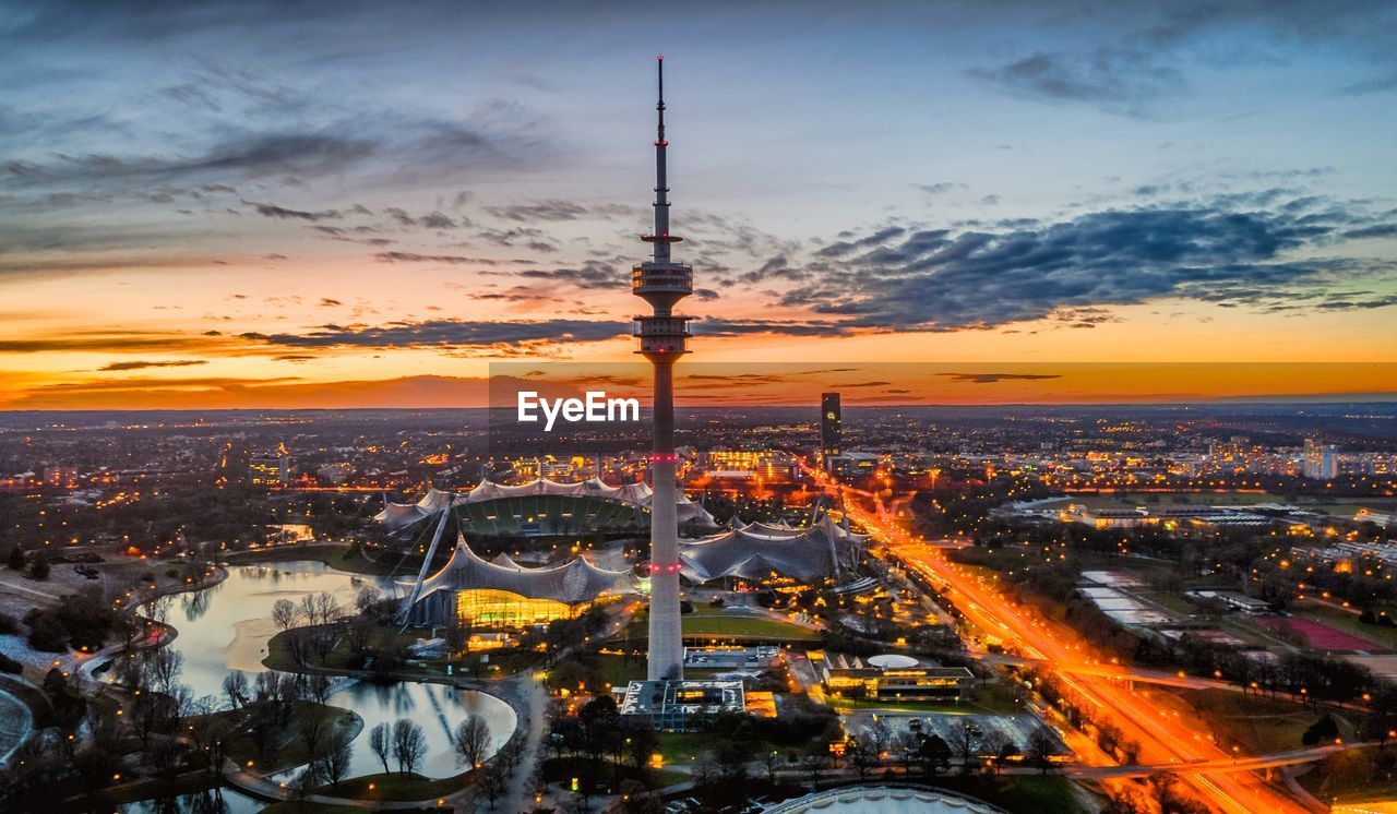 High angle view of illuminated city against sky during sunset