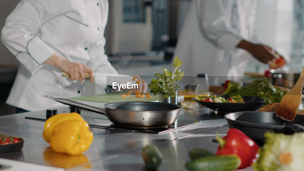 midsection of chef preparing food