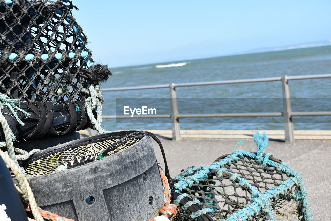 Stack of rope on beach against clear sky