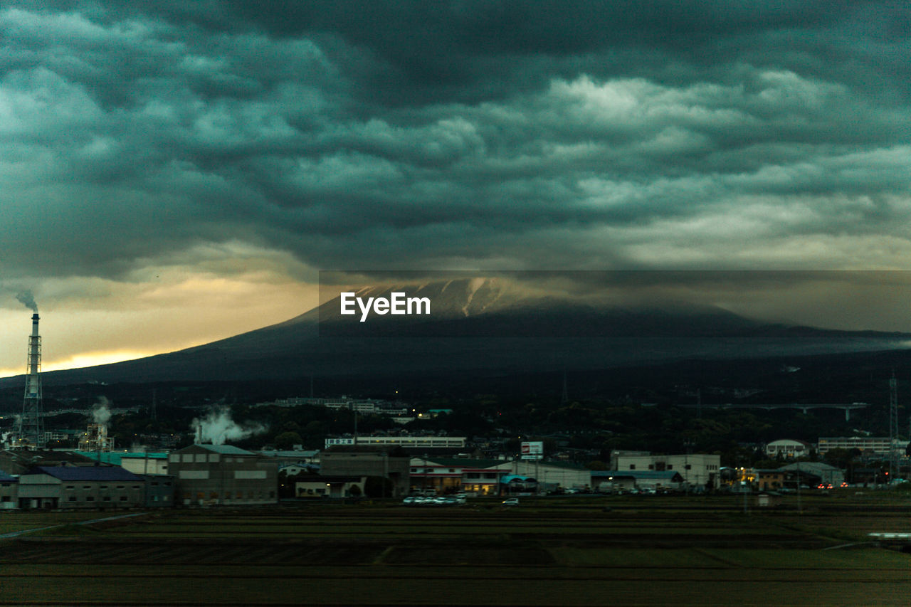 STORM CLOUDS OVER CITY DURING DUSK