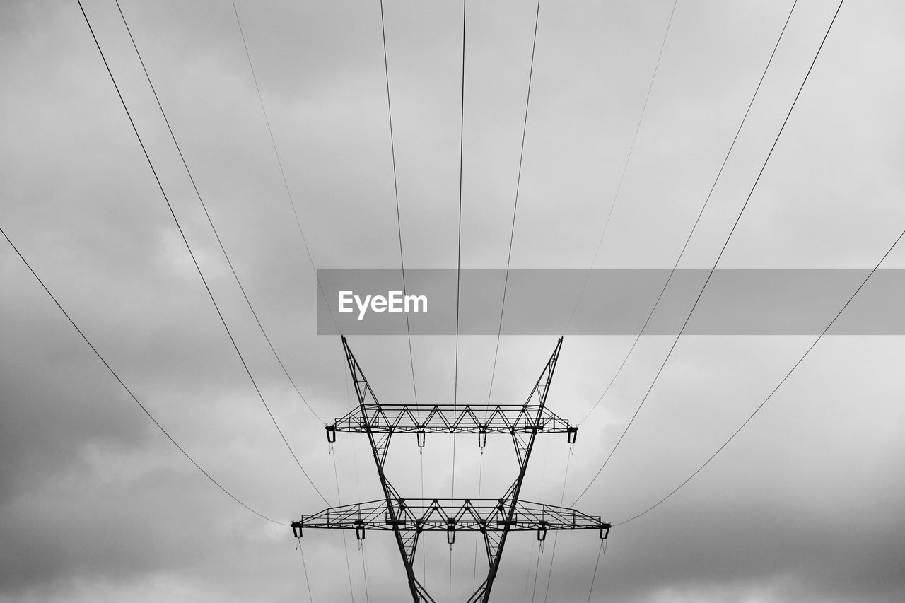 Low angle view of electricity pylon against sky