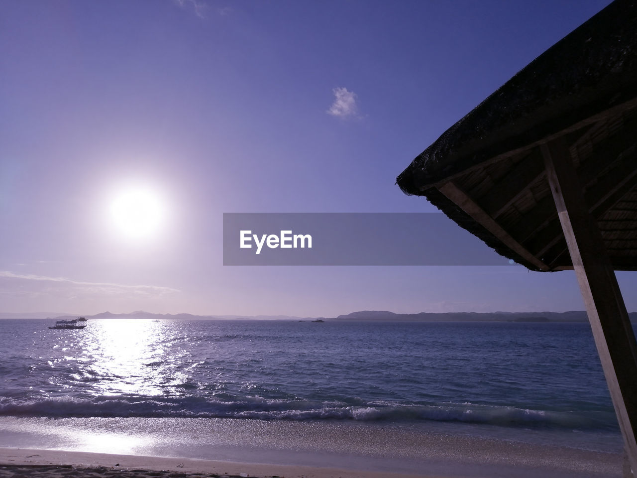 SCENIC VIEW OF BEACH AGAINST SKY AT SUNSET