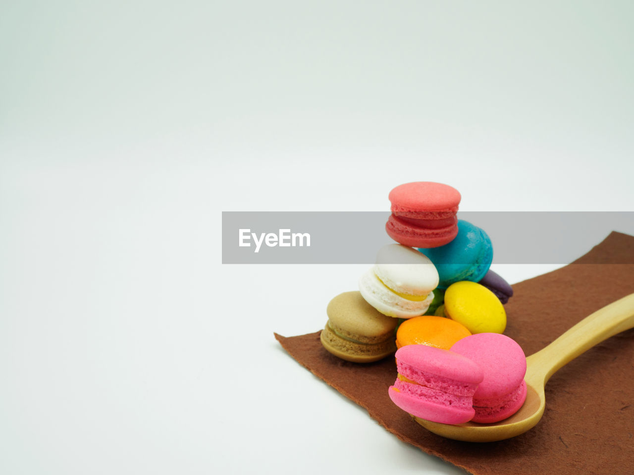 Close-up of multi colored macaroons against white background