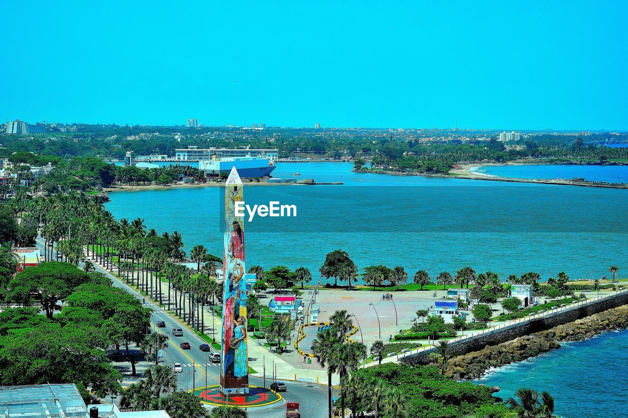 High angle view of obelisk by sea against clear sky