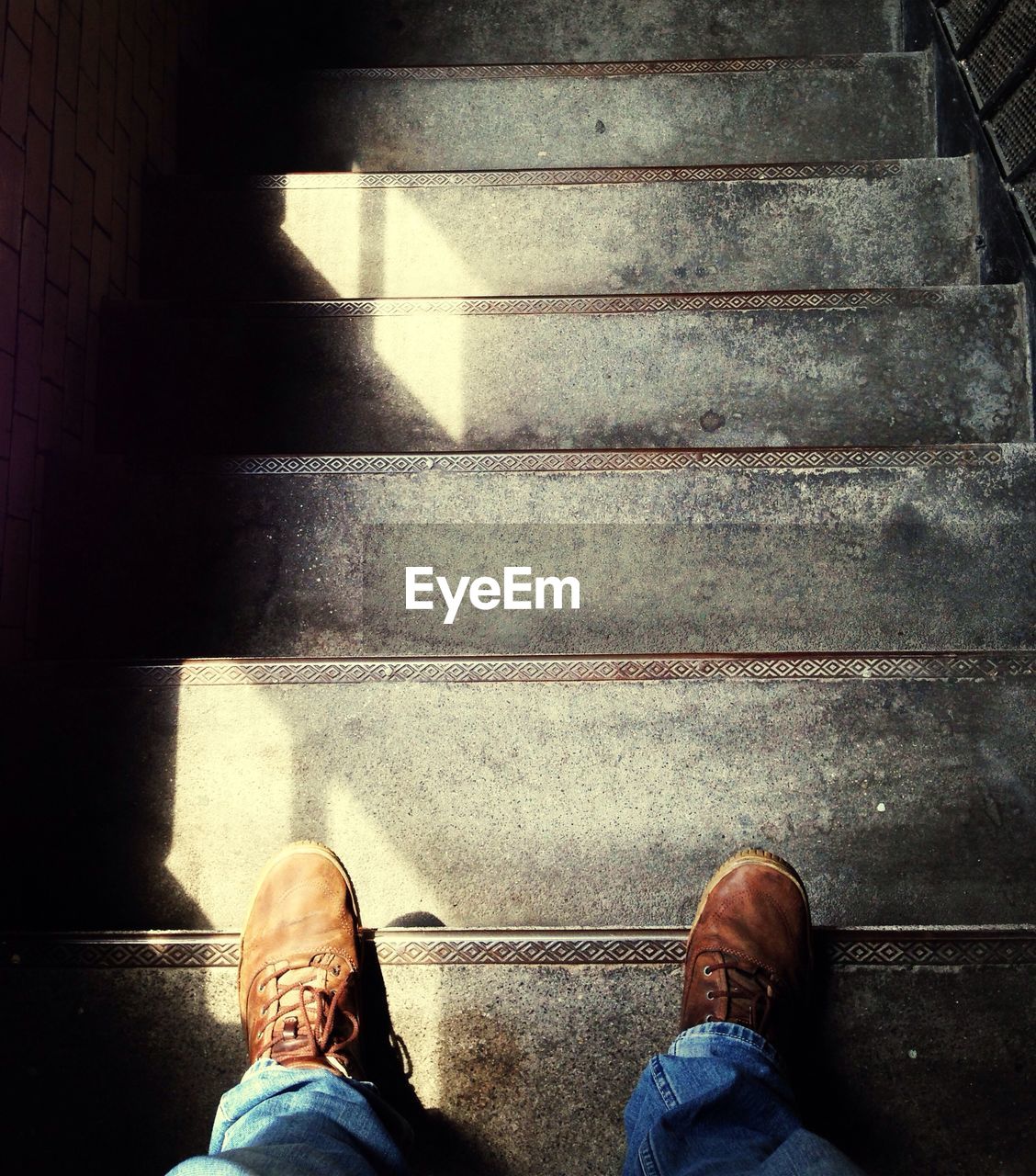 Man standing at top of stairs looking down