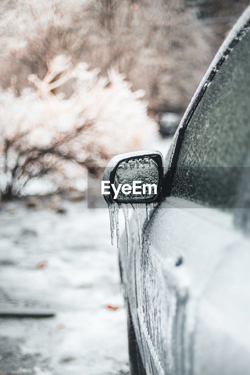 CLOSE-UP OF SNOW COVERED CAR