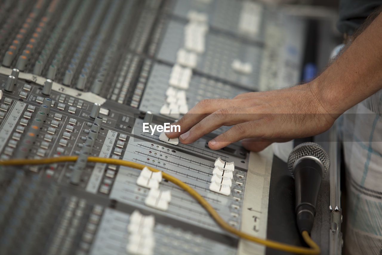 Close-up of hand using sound mixer