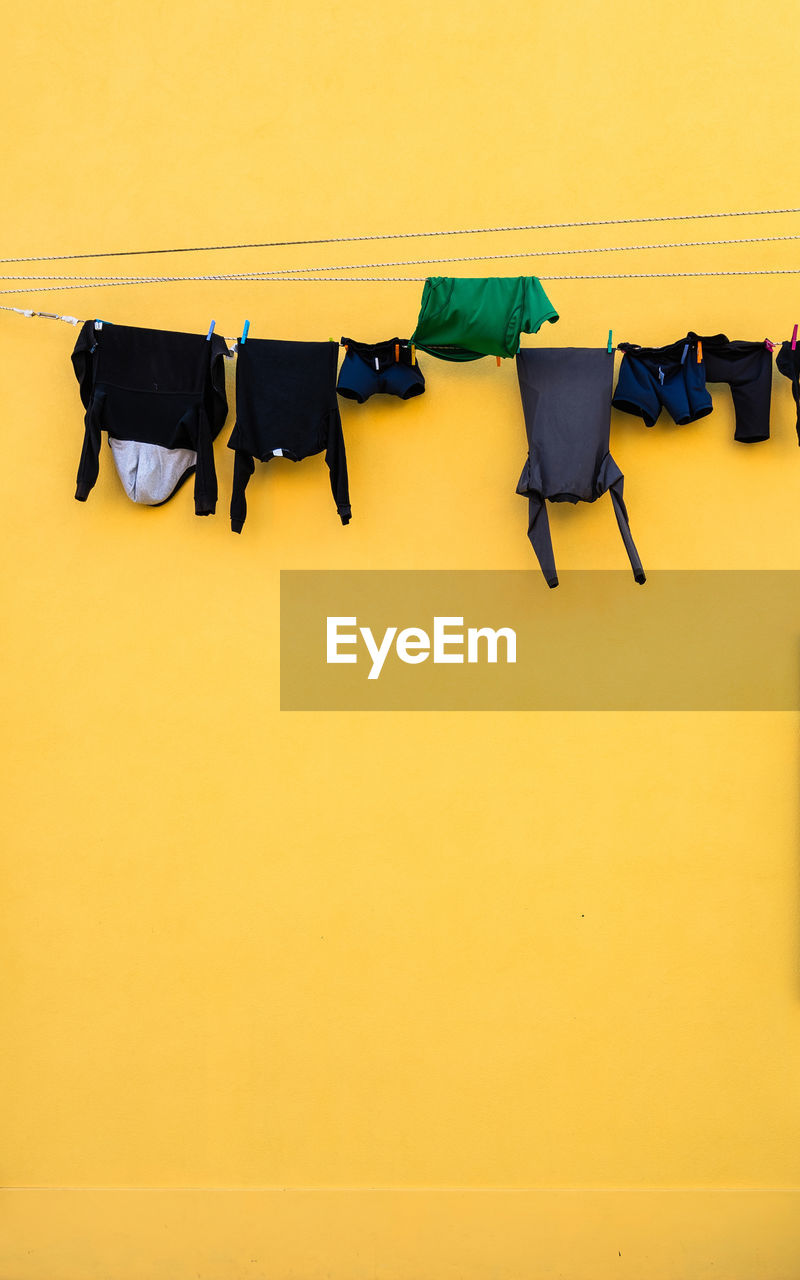 HIGH ANGLE VIEW OF CLOTHES DRYING ON WALL