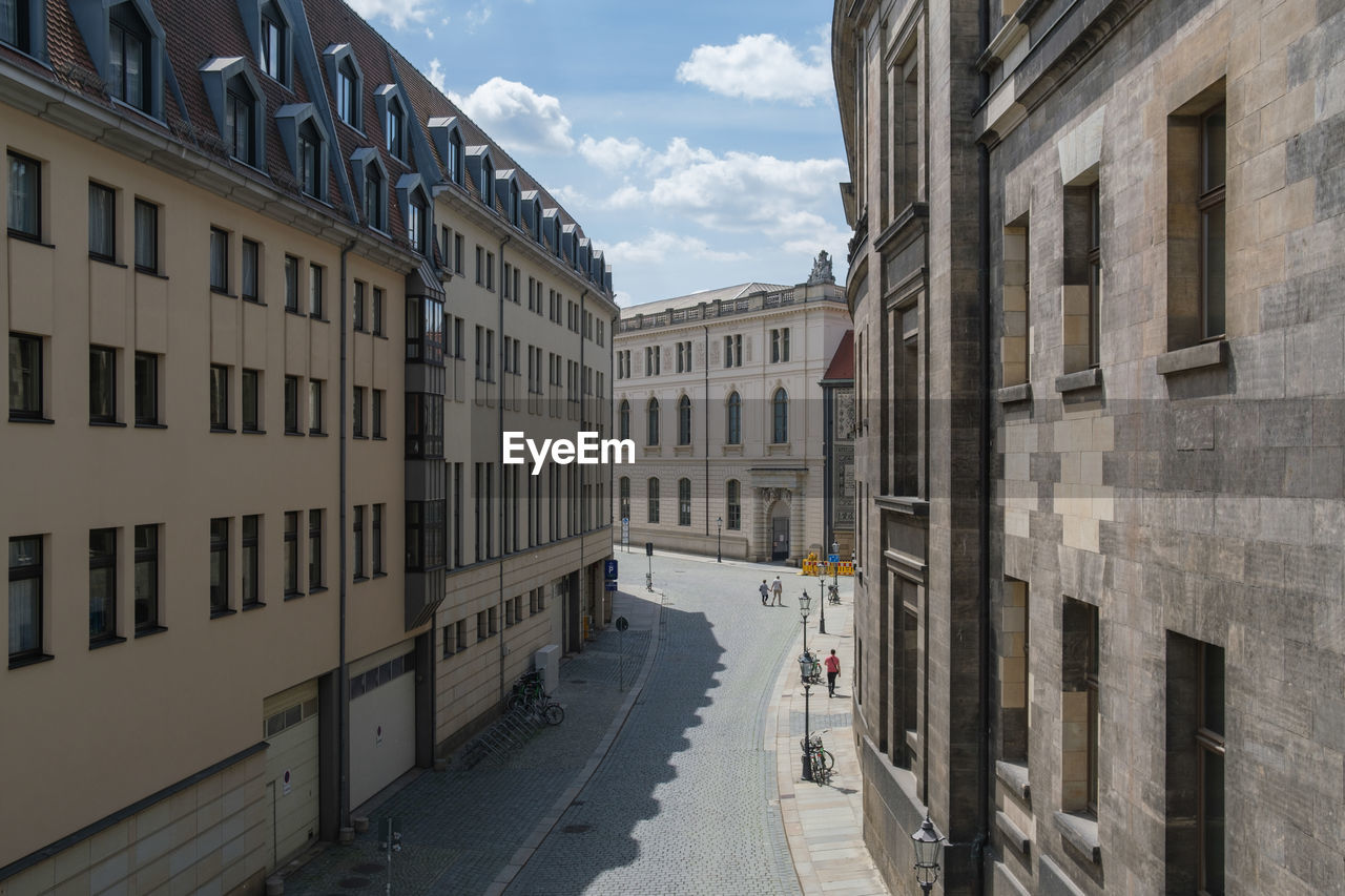 Street amidst buildings in city against sky